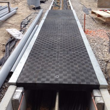 Trenwa’s heavy-duty precast concrete road crossing trenches topped with Fibrelite’s traffic rated composite trench covers